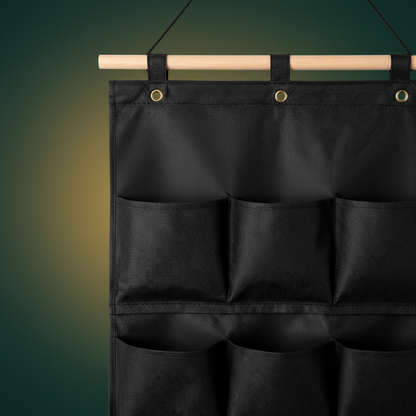 Close-up detail of the black fabric texture, pocket seams, hanging loops and varied pocket depths