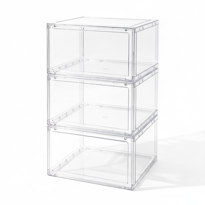 Three empty stacked clear shoe boxes on a white background